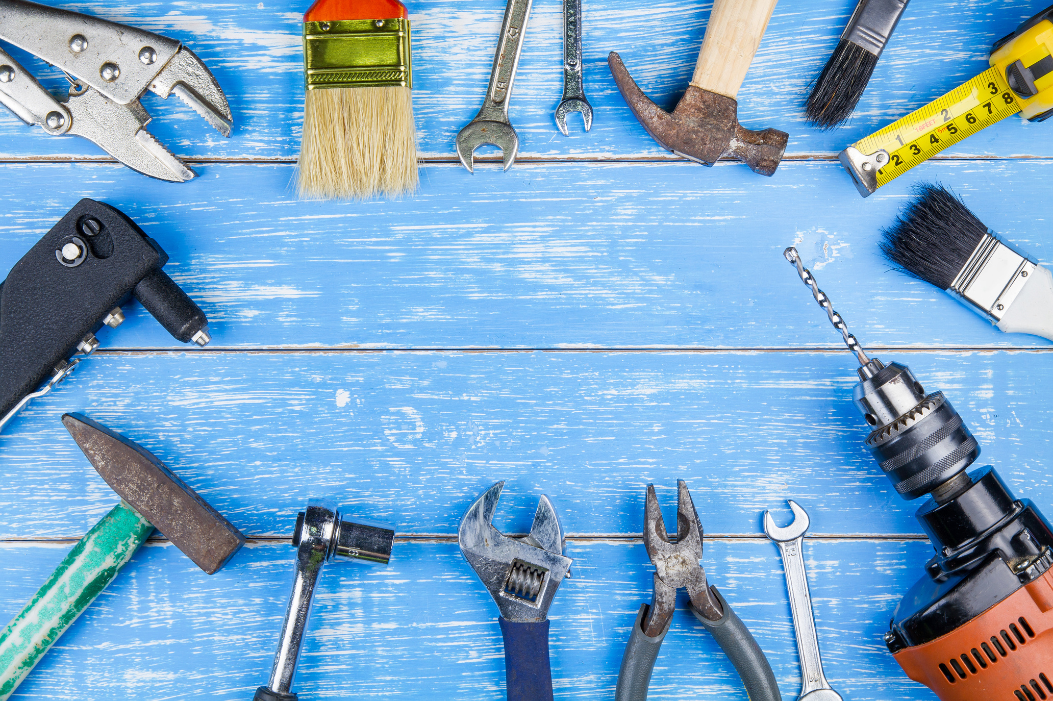 Construction tools on blue wooden table background